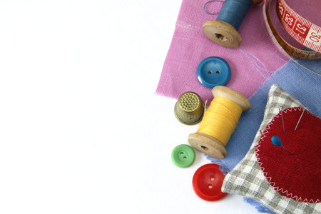 button needle thread thimble cloth meter on a white background