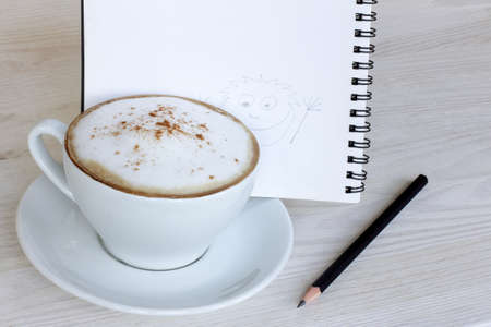 refreshing cup of cappuccino with cinnamon and cheerful pattern for moodの写真素材