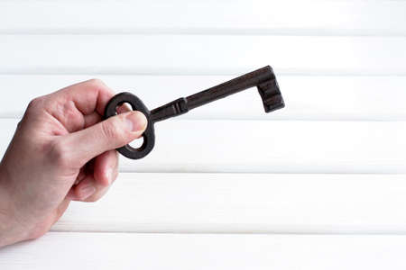 old retro huge key in the human handの写真素材