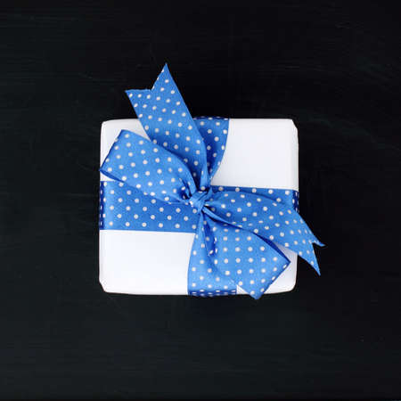 background festive gift package with blue ribbon top viewの写真素材