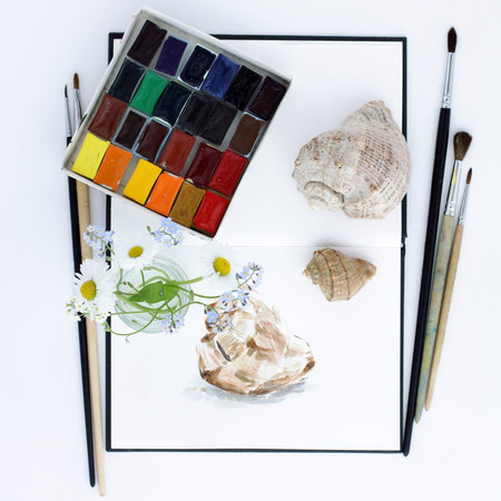 Art objects notebook, paint, brush, flowers, and seashells, flat lay, top view