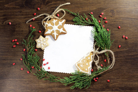 Festive Christmas background with figure with ginger cookies and firtrees top view / a magic...