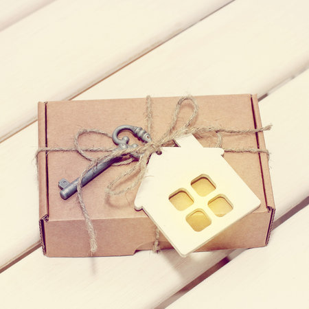 gift with attached to it a symbol of home and the key to his / mega festive surprise