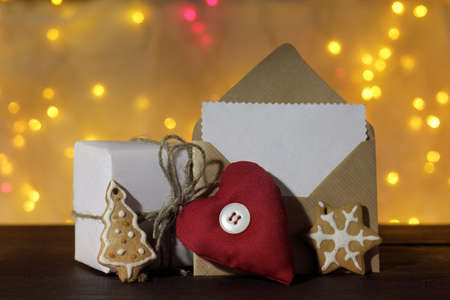 Christmas concept with gift, gingerbread and envelope for congratulation on a background of holiday lights /  Christmas fantasyの写真素材