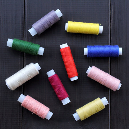 spool of thread of different colors top view / reel of thread