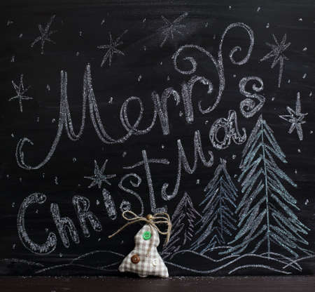 tree decorated with soft buttons on the background of the school board with a festive pattern / Merry Christmas greetingsの写真素材