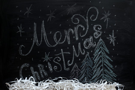 Festive decorations on a background blackboard with the inscription in chalk / painted greetings...