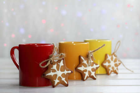 gingerbread stars with colored circles on a background of festive lights / warm and homely atmosphere of a holidayの写真素材