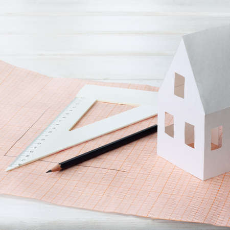 paper model house with a ruler and pencil / future planning areaの写真素材
