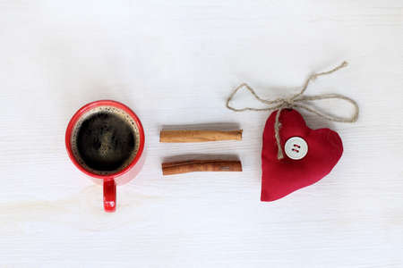 natural black coffee with cinnamon sticks aromatic and heart symbol / coffee equals loveの写真素材