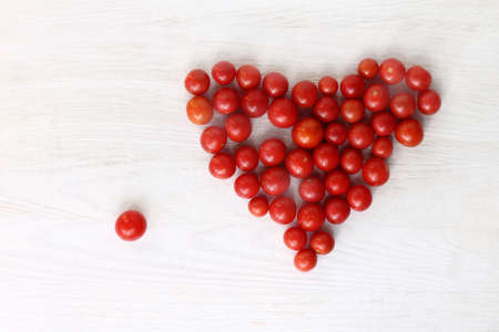 Heart concept gathered from small tomatoes top view / important missing pieceの写真素材