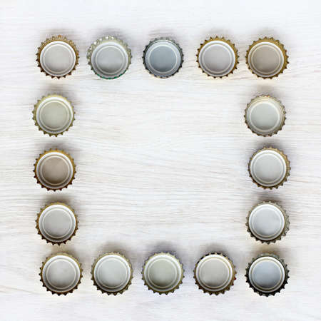 blank square frame of turned upside down bottle caps / picture for pubの写真素材