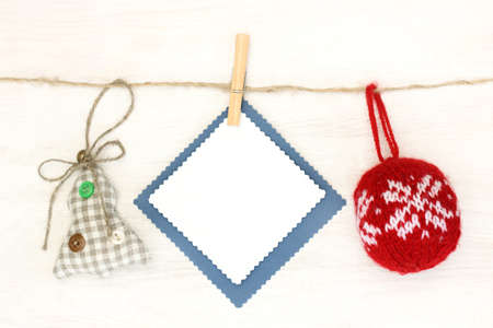soft red ball with ornaments and Christmas tree made by hand hanging on a rope / shockproof congratulation to holidayの写真素材