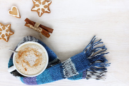 Coffee with frothed milk and cookies on the figure a light wooden surface top view / holiday flavor in the warming atmosphereの写真素材
