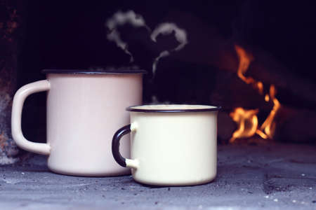 two iron circles retro heated by on the old fireplace / secluded romantic love trystの写真素材