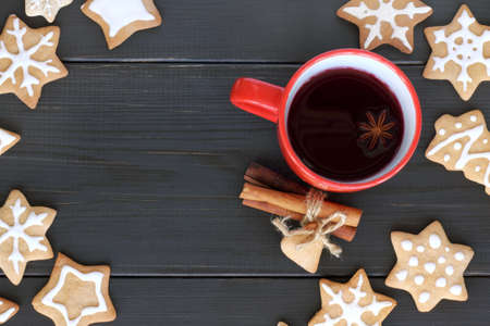 flat layout with red mug filled with a warming drink, surrounded by a shaped cookies top view / tea with a festive aromaの写真素材