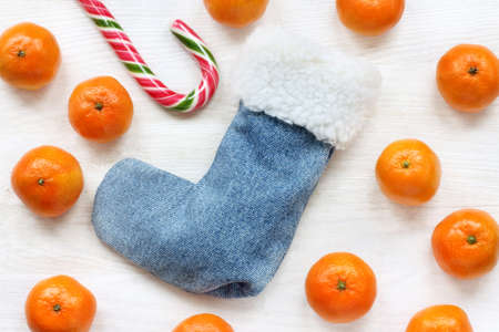 flat layout with a warm boot, sweet staff and orange fruit top view / part Santa outfits in Mandarinの写真素材