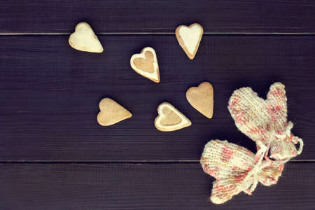 flat layout figured cookies, heart-shaped and knitted mittens top view / share warmest feelingsの写真素材