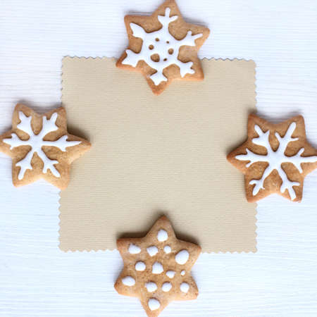 flat layout of the cookies in the form of stars and snowflakes around blank slate / wishes for happyの写真素材