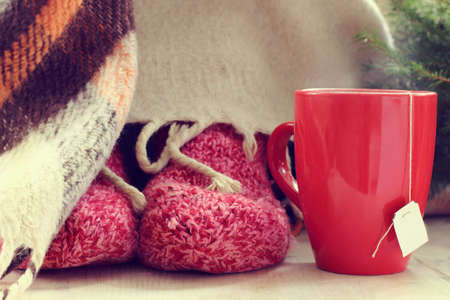 red mug with a hot drink in the warming atmosphere near the Christmas tree / Heat mood and comfortの写真素材