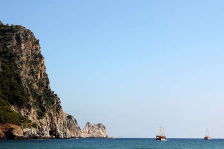 waterscape with retro ships sailing near  the steep coast / adventure travelの写真素材