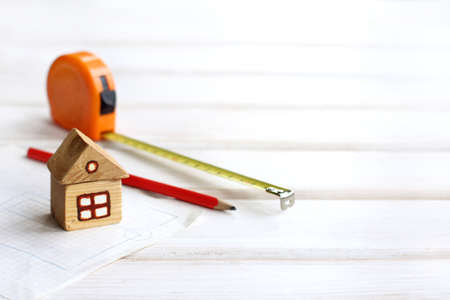 blurred outlines of houses layout, pencils and roulette are on the site plan / individual housing constructionの写真素材