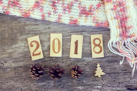 Flat layout with wooden numbers and a knitted scarf on an old wooden surface top view / warm Christmas 2018の写真素材