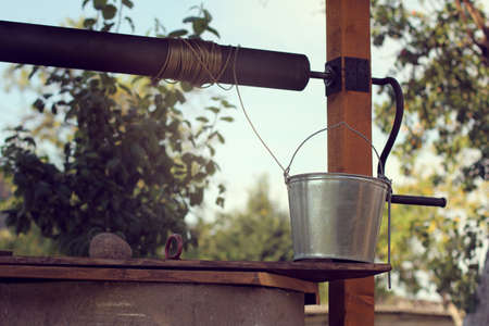 Bucket for water set at the edge of a village wellの写真素材