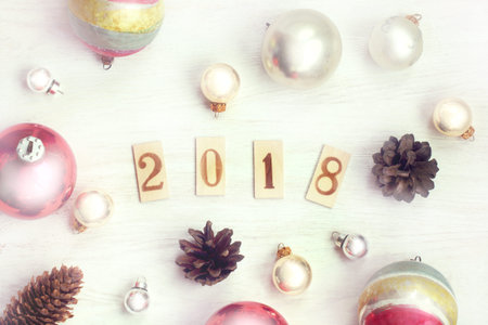 flat layout of festive balls and cones with the date of the coming year top view / winter...
