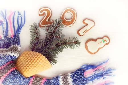 installation from scarf, waffle horn, spruce branches and figured gingerbread on table top view / concept happy winter vacationの写真素材