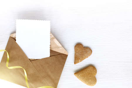 open letter with pure patterned blank and two gingerbread cookies in the shape of heart / festive love messageの写真素材