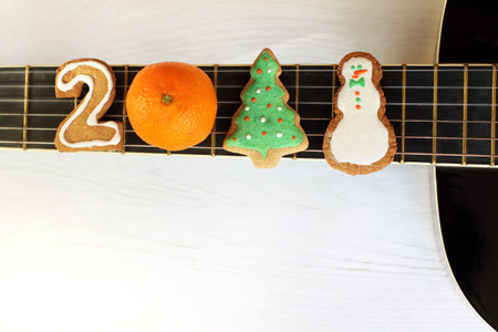 ginger number two, orange tangerine, decorated Christmas tree and cheerful snowman on the background...