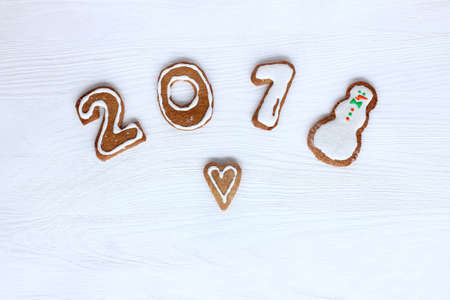 figured gingerbread with glaze in the shape of a heart, figures and a snowman top view / favorite merry sweet 2018の写真素材