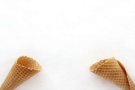 two empty wafer horns on a light surface / without anythingの写真素材