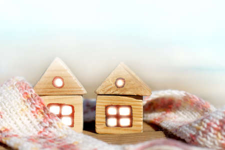 Two wooden home together are insulated with a pink scarf / townhouse with cozy neighborsの写真素材