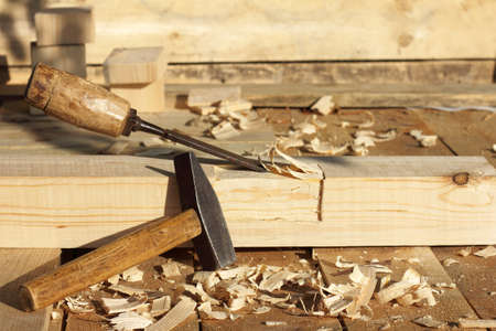 hammer and chisel against the background of the wood / carpentry work outdoorsの写真素材