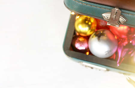 open old suitcase lid and blurred silhouettes of toys and decorations top view / Christmas holiday travelの写真素材