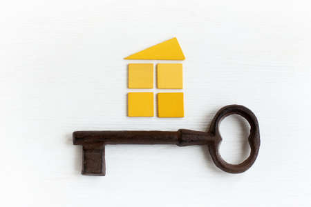 small yellow house and a large retro key / Victorian solutions for livingの写真素材