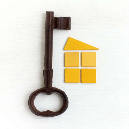 large metal key and a symbol of the house / non-standard solutions for lifeの写真素材