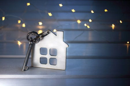 house and key against the evening lights / hotel for rest and entertainment
