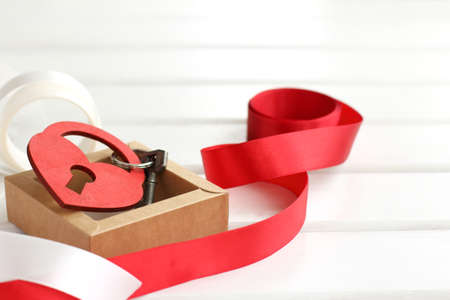 heart valentine in the form of a lock with key adorned with ribbons / festive hintの写真素材