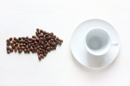 coffee bean arrow points to an empty cup top view. fresh espresso will be here soon