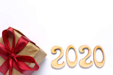 gift with a bow and a number denoting the year on a light background top view. holiday surprise 2020の写真素材