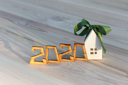 layout of the house in a green ribbon with a bow and the number of 2020. ready-made solution in gift packagingの写真素材