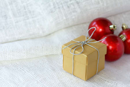 holiday gift on a background of red balls. getting ready for christmasの写真素材