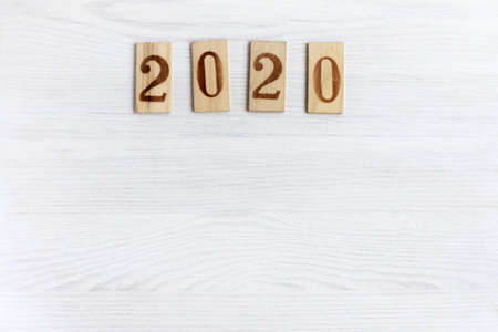wooden plates with numbers on a light wooden background, top view. 2020 and a lot of empty spaceの写真素材