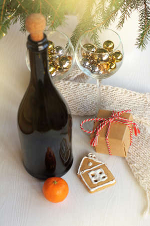 ginger house and orange fruit with a gift on the festive table. winter holiday new year still lifeの写真素材