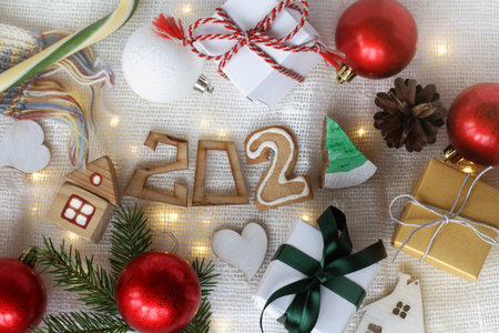 flat lay of different winter holiday items on the table top view. gifts and decorations 2021