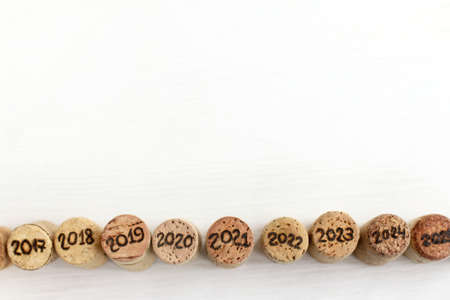 collection of wine corks of different years on the table top view. past and future winemakingの写真素材
