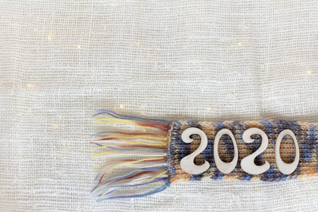 installation with a scarf and numbers on a fabric with garland lights top view. festive background...